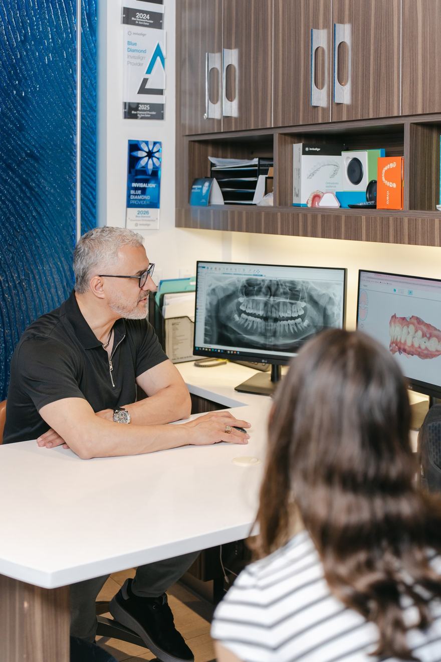 Dr. Daher going through a treatment plan and its cost at his consultation desk